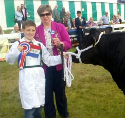 Kile Diamond receiving his Champions prizes from the Judge